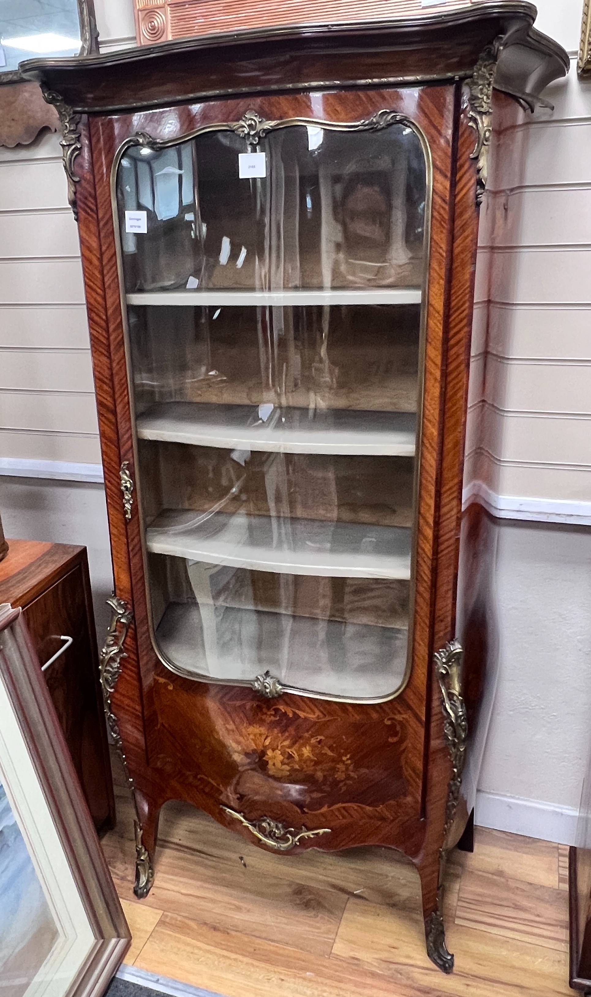 A Louis XVI style gilt metal mounted marquetry inlaid kingwood bombe vitrine, width 86cm, depth 40cm, height 160cm